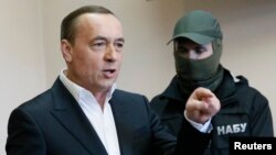 Former lawmaker Mykola Martynenko speaks during a court hearing in Kyiv on April 21.