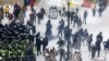 Police clash with supporters of former Georgian President Mikheil Saakashvili in a tent camp in front of the Ukrainian parliament in Kyiv on February 27.