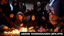 Iranians light candles for victims of the downed flight in Tehran on January 11. 