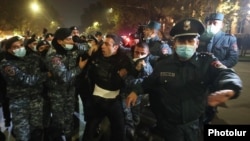 Armenia -- Riot police detain an opposition protester in Yerevan, December 1, 2020.