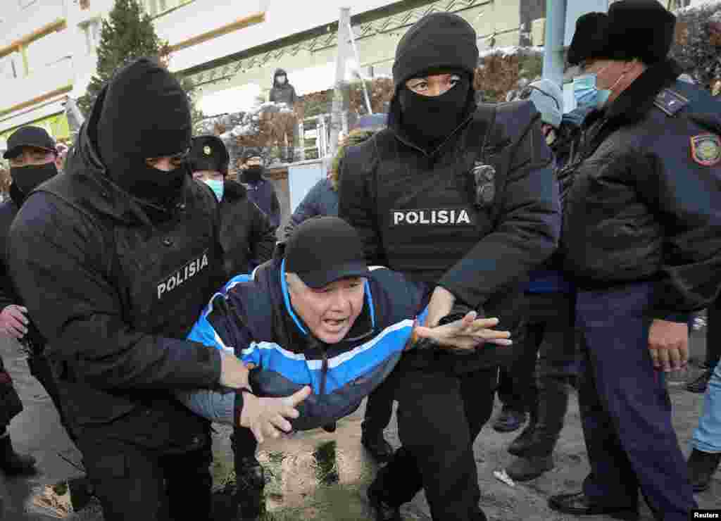 Kazakh police detain a man during a protest denouncing what opposition supporters called political repression in Almaty on February 28. (Reuters/Pavel Mikheyev)