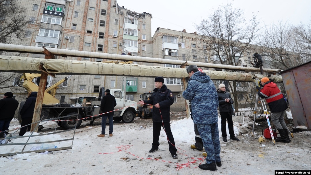 Members of the emergency services gather near a damaged apartment block after an apparent gas explosion in the town of Shakhty on January 14.
