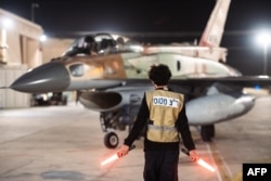 An Israeli fighter jet departs a hangar at an undisclosed location in Israel.