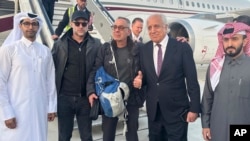 US citizen George Glezmann (center) poses with Adam Boehler (second left) and Zalmay Khalilzad (second right) and Qatari diplomats in Kabul, Afghanistan, March 20, 2025, before departing to Doha, Qatar.