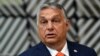 Hungarian Prime Minister Viktor Orban addresses the media as he arrives on the first day of the EU summit at the European Council building in Brussels on June 24.