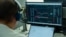 Un bărbat urmărește fluctuația cursului de schimb BTC (Bitcoin) - USDT pe una din platformele de tranzacționare a criptovalutelor. Imagine ilustrativă