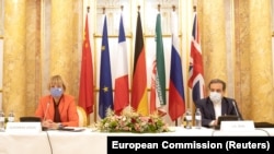 AUSTRIA -- Iran's top nuclear negotiator Abbas Araqchi and Secretary General of the European External Action Service (EEAS) Helga Schmid attend a meeting of the JCPOA Joint Commission in Vienna, September 1, 2020