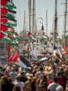 Spain - People crowd the dock ahead of the launch of a civilian flotilla bound for Gaza, aiming to break the Israeli blockade and deliver humanitarian aid in Barcelona, Spain, Sunday, Aug. 31, 2025.