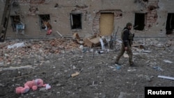Український військовий поруч зі зруйнованим будинком у Часовому Яру, 5 березня 2024 року