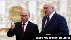 Belarusian President Alyaksandr Lukashenka (right) meets with Russian President Putin in Minsk on June 19