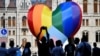 People gather in front of a huge rainbow balloon put up by members of Amnesty International and Hatter, an NGO promoting LGBT rights, outside Hungary's parliament in Budapest on July 8.