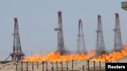 Flames emerge from a pipeline at Rumaila oilfield in Basra, May 11, 2017