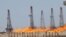 Flames emerge from a pipeline at Rumaila oilfield in Basra, May 11, 2017