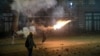 A protester launches a firework amid clashes with police in central Tbilisi in the early hours of December 4. 