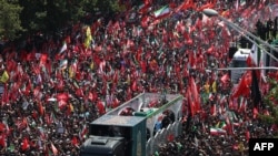 People gather along a street during the funeral procession of late Iranian Supreme Leader Ayatollah Ali Khamenei in Tehran on July 6.
