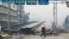 Syria -- A woman crosses the Al-Haj highway, which is closed because of sniper fire by pro-government forces, in Aleppo, January 20, 2015