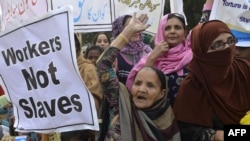 Pakistani NGO activists and working women shout slogans during a rally held to mark International Human Rights Day in Lahore (file photo)