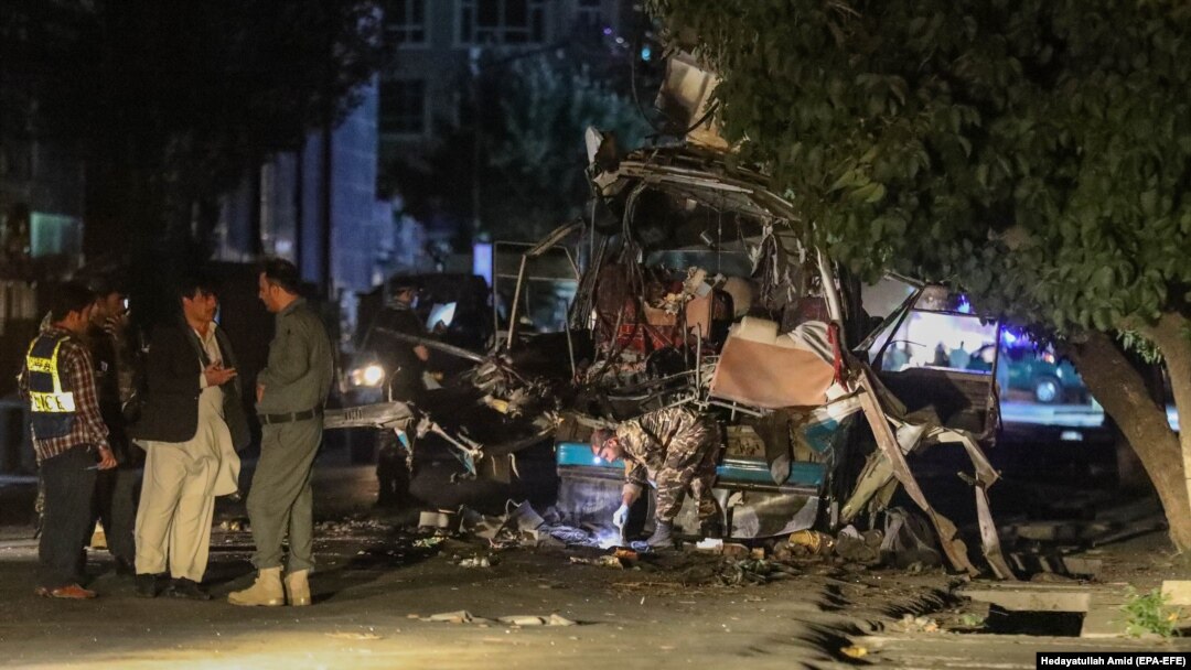 Afghan security officials inspect the scene of a bomb blast in Kabul on June 1.