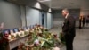 UKRAINE -- An airport employee looks at a makeshift memorial inside Borispil international airport in Kyiv, January 10, 2020