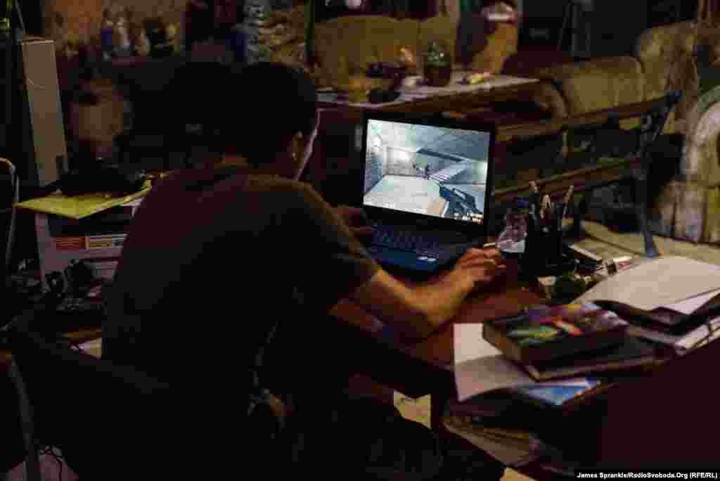 A young soldier from the 93rd Brigade plays a video game, Counter Strike, during a break.