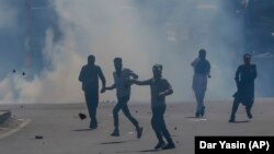 Kashmiris face Indian police officers during a protest in Srinagar in Indian-controlled Kashmir on May 25.