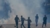 Kashmiris face Indian policemen during a protest in Srinagar, Indian-controlled Kashmir, on May 25, 2018. 