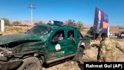 Afghan police inspect the site of a suicide attack in Parwan Province on September 17.