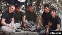 A screen grab from a video posted on an Islamist website, in which five men pledge allegiance to the extremist group. At least one of them resembles one of three suspects whose photographs were released by Tajik authorities in connection with a deadly attack on foreign cyclists on July 29. 