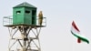A Tajik border patrol officer stands on an observation tower at the Somon border outpost. (file photo)