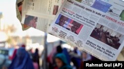 AFGHANISTAN -- A local newspaper front-pages the U.S. presidential election between President Donald Trump and Democratic challenger Joe Biden, at a shop in Kabul, November 5, 2020