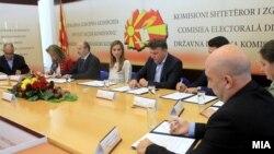 Candidates for mayor of Macedonia's capital, Skopje, sign documents.