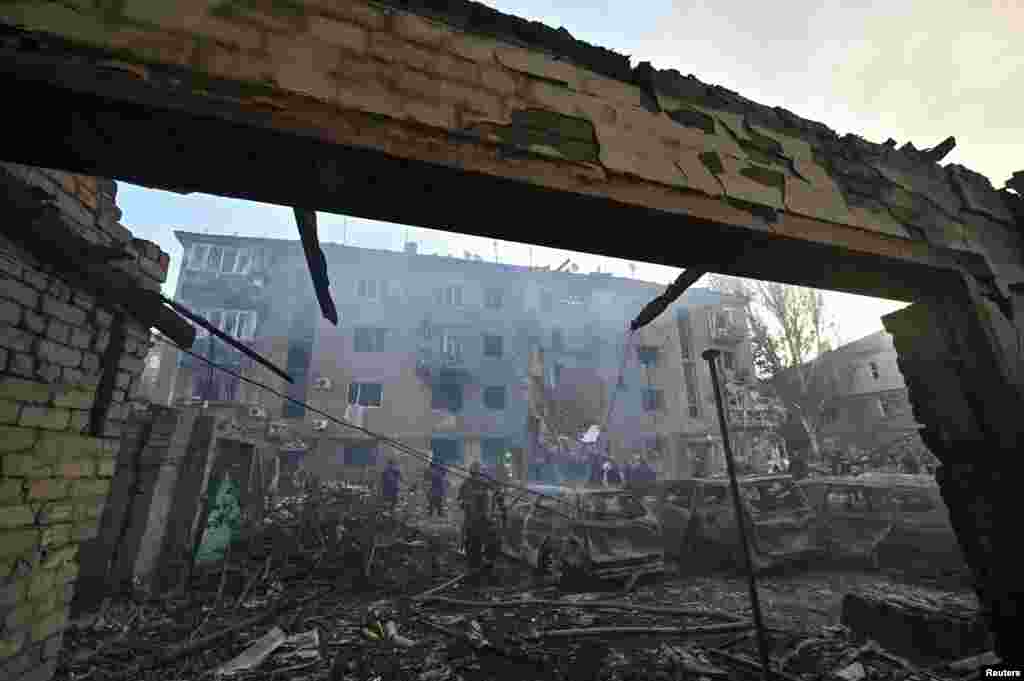 Rescuers work at the site of an apartment building hit by a Russian air strike in Zaporizhzhya, Ukraine