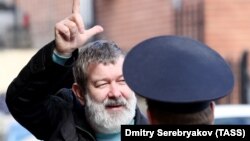 Video blogger Vyacheslav Maltsev is escorted to court in Moscow on April 14.