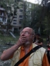 A man reacts to the sight of a destroyed apartment block in Kyiv on the morning of June 17. 