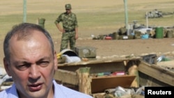 Daghestan's President Magomedsalam Magomedov speaks to the media at a blast site in a military camp outside the town of Buynaksk on September 5. 