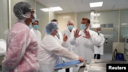 France - French President Emmanuel Macron speaks to a group of researchers as he visits an industrial development laboratory at French drugmaker's vaccine unit Sanofi Pasteur plant near Lyon, France June 16, 2021.