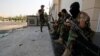 Iraqi security forces stand guard near government buildings in Basra on September 5.