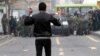 An Iranian opposition protester faces security forces during clashes in Tehran in December 2009, following the reelection of Mahmud Ahmadinejad as president.