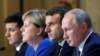 Ukrainian President Volodymyr Zelenskiy, (left to right) German Chancellor Angela Merkel, French President Emmanuel Macron, and Russian President Vladimir Putin attend a press conference after a summit on Ukraine at the Elysee Palace in Paris in December 2019.