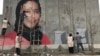 The mural in Kabul of slain human rights activist Hamida Barmaki as it was being painted. 