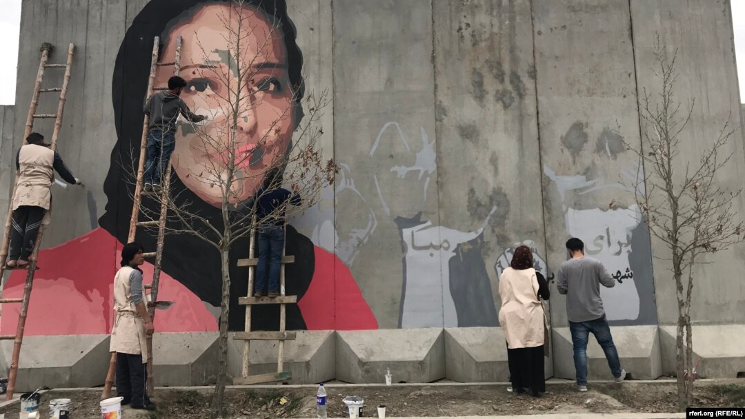 The mural in Kabul of slain human rights activist Hamida Barmaki as it was being painted. 