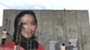 The mural in Kabul of slain human rights activist Hamida Barmaki as it was being painted. 