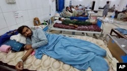 Injured victims of a rainstorm are treated at a hospital in Bannu, a town in Pakistan's Khyber Pakhtunkhwa Province, on June 10. 