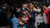 HONG KONG -- People line up to get free vitamin C tablets and bottles of hand sanitiser in Hong Kong, China, 24 January 2020. 