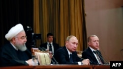 Iranian President Hassan Rouhani (left), Russian President Vladimir Putin (center) and Turkish President Recep Tayyip Erdogan (right) attending a press conference following a trilateral meeting on Syria in the Black Sea resort of Sochi, February 14, 2019.