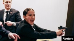 Security officials respond as the incident in the Washington Hilton hotel unfolds.