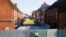 A British police officer on July 5 stands in front of screening erected in Amesbury, Britain, as forensic tents are erected after officials said it was confirmed that two people were poisoned with the nerve agent Novichok.