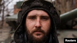 "Mehan," a Ukrainian tank unit crew member, poses for a portrait after returning from a mission at the front line near the bombed-out eastern Ukrainian city of Bakhmut on March 29.