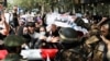 Taliban soldiers stand in front of demonstrators during a protest in Kabul on September 7.