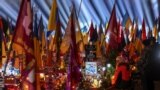 People visit graves of their relatives at a military cemetary in Lviv